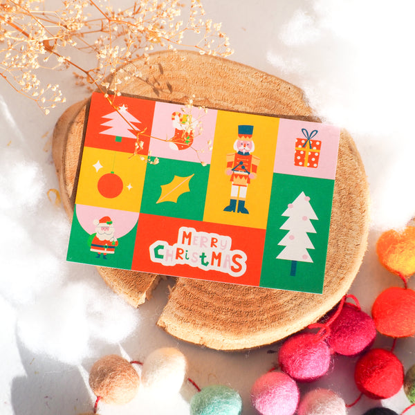 Christmas card with tree, ornament presents and santa design with words "Merry Christmas".